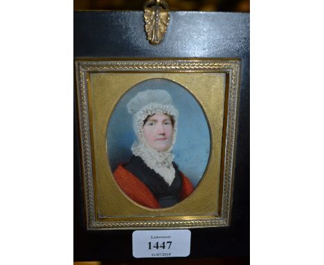 19th Century English school, watercolour, portrait miniature of a lady wearing a lace bonnet and red shawl, inscribed verso '