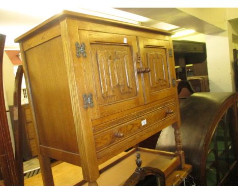 20th Century oak side cabinet having two panelled linen fold carved doors above a single drawer and pot shelf