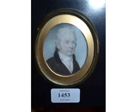 Early 19th Century watercolour, portrait miniature of a gentleman wearing a brown jacket, oval mounted in an ebonised and gil
