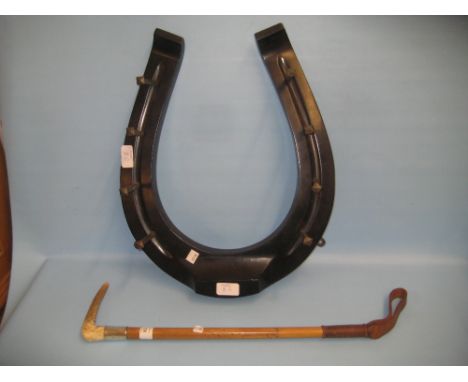 Early 20th Century whip / riding crop rack in the form of a horseshoe, together with a silver mounted riding crop