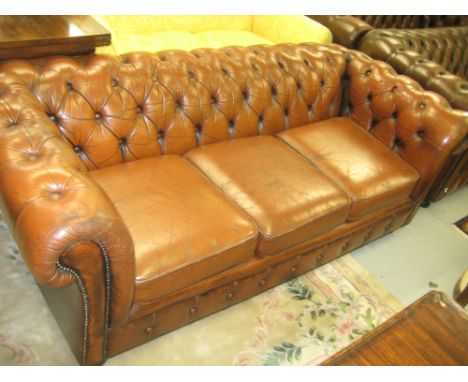 Mid brown button leather upholstered three seat Chesterfield style settee