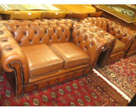 Brown leather button upholstered and brass studded two seater Chesterfield sofa together with a matching armchair