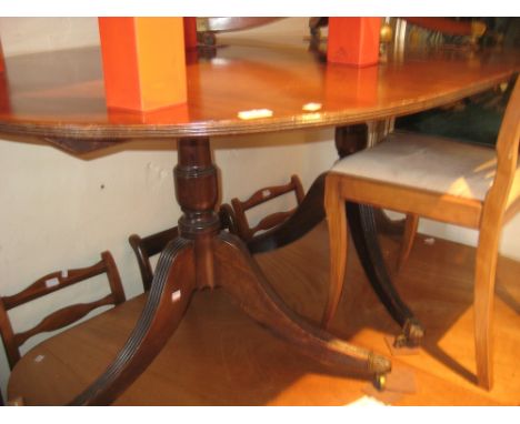 Mahogany twin pedestal dining table with reeded top and D ends on tripod bases