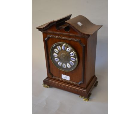 Edwardian mahogany cased mantel clock, having broken arch pediment above a circular gilt dial with enamelled cattrouche with 