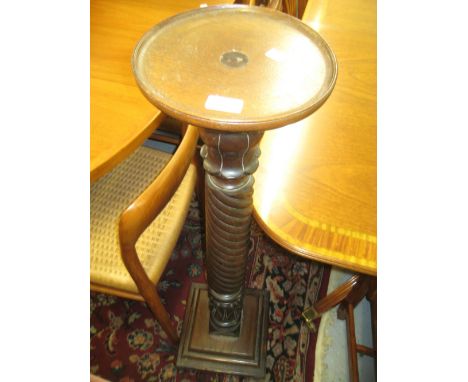 Pair of carved mahogany bed post torcheres with circular dish tops, spiral columns and square stepped platform bases