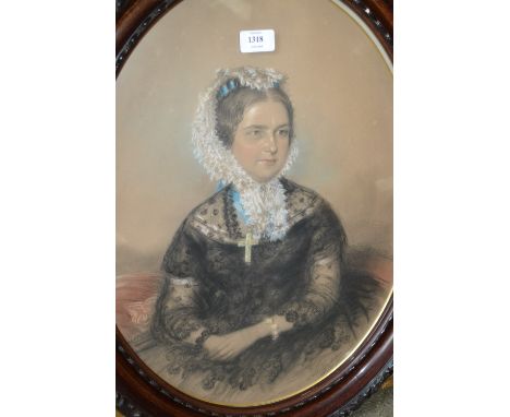 A. Blackley, pastel portrait of a seated Victorian lady wearing a white bonnet, dated 1870, mounted in an oval simulated wood