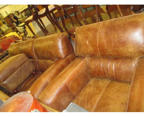 Modern mid brown leather upholstered three seat sofa, a matching armchair and box footstool