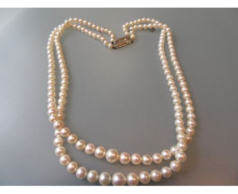Double row graduated cultured pearl necklace with diamond chip set clasp