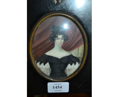 19th Century watercolour, portrait miniature of a lady wearing a black dress seated before a red curtain, signed with initial