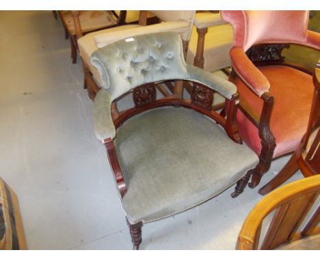 Late 19th Century walnut tub shaped chair having button upholstered back, raised on turned tapering supports with casters