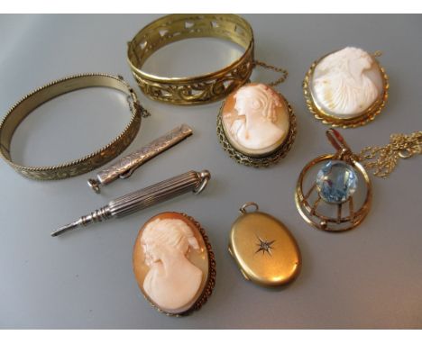 Victorian yellow metal diamond set pendant locket, together with three various oval carved shell cameo portrait brooches, two
