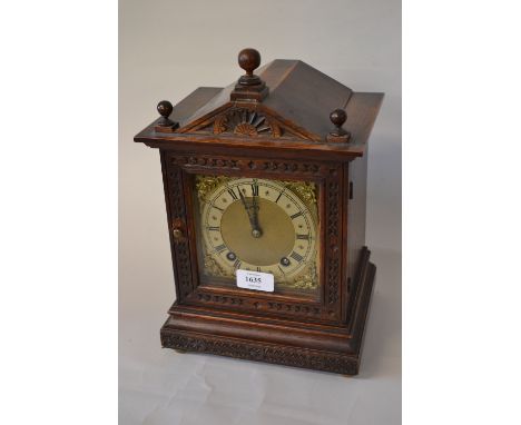 Late 19th Century continental oak arched top mantel clock with a two train movement striking on a gong
