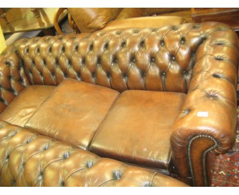 20th Century brown button upholstered leather three seat Chesterfield sofa with loose cushions, on bun supports