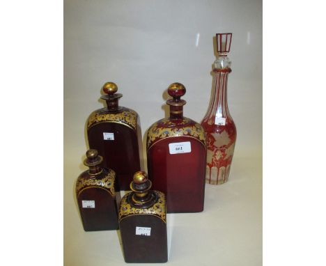 Pair of antique ruby glass and gilt decorated decanters with stoppers together with a pair of matching smaller decanters and 