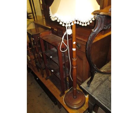Turned stained beech standard lamp and a wrought iron standard lamp