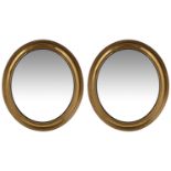 A pair of late 19th/early 20th century gilt brass framed oval mirrors (2)