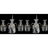 A pair of late Regency cut glass three light wall appliques in the manner of Osler