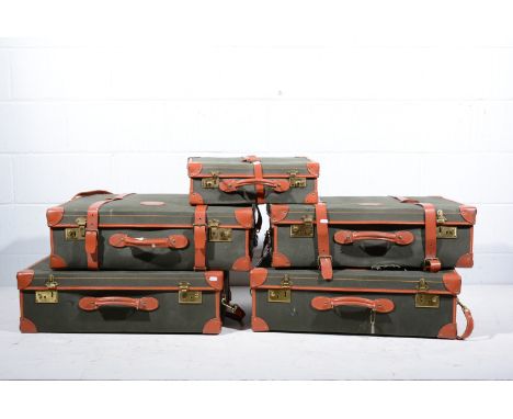 Four large Papworth leather and canvas trunks, and one smaller trunk, together with a quantity of matching ring-binder folder