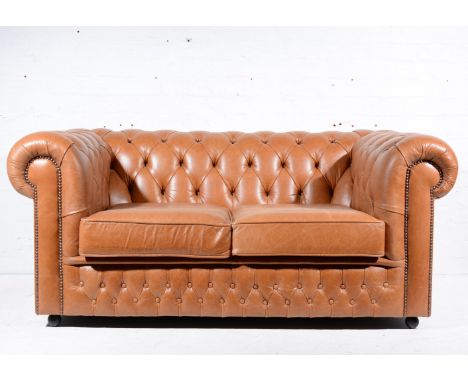 Two seat Chesterfield settee with saddle covered leather, by Saxon of England.