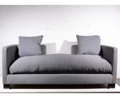 Contemporary grey three seater sofa with cut out back, black and chrome block supports.