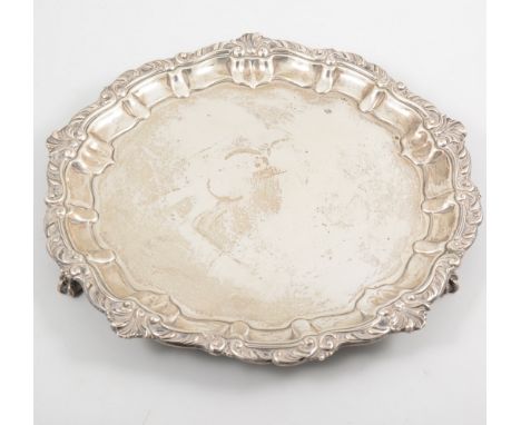 A Victorian silver salver, stylised shell and scroll border supported on three claw feet, 30cm diameter, hallmarked Sheffield