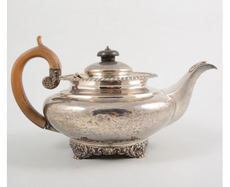 George IV silver teapot, squat form, gadrooned collar, shell and foliate foot. hallmarked London 1828, makers mark William Ba