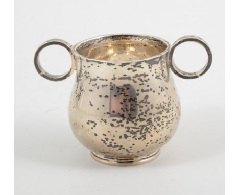 A small silver christening mug, with two ring handles, 7cm, hallmarked Chester 1912, by Walford & Spokes, Oxford on base, app