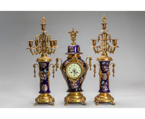 antique 3pc garniture in brass and ceramic with a pair of candelabra and a clock with  marked workAntieke driedelige schouwga