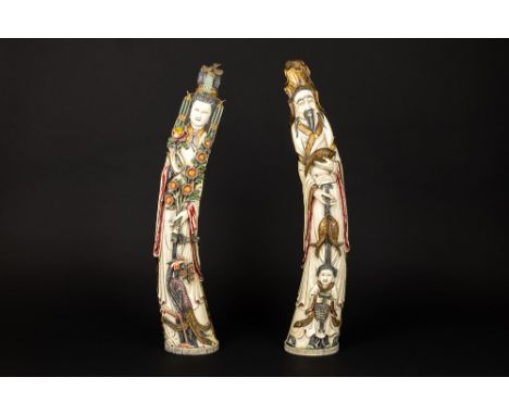 pair of old Chinese sculptures in partially polychromed ivory with the depiction of the emperor and empress as "Man with fish