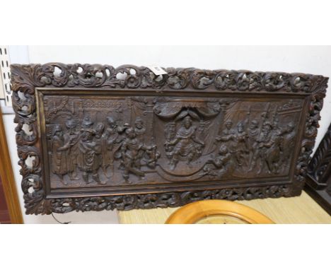 A 17th century style carved oak panel, 'The judgement of Solomon', 95cms wide x 45cms high