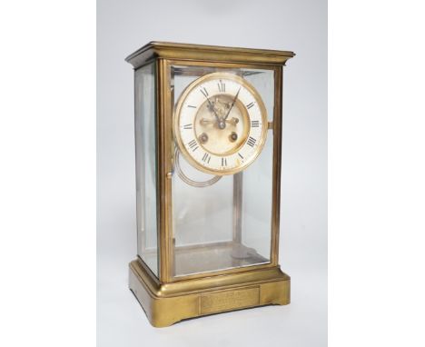 An Edwardian brass four-glass mantel clock with pendulum, presentation plaque to base, 30cm tall