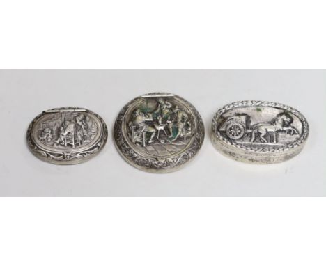 Two 19th century Dutch white metal snuff boxes, circular 56mm and oval and an 800 standard oval snuff box, decorated with hor