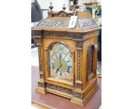A 19th century architectural walnut bracket clock, with key and pendulum. 53cm tall