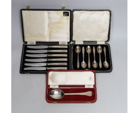 Three cased sets of silver flatware including a 1953 Commemorative dog nose spoon, six teaspoons and six tea knives.