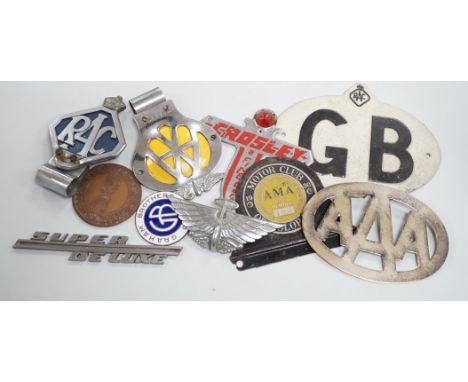 A mixed collection of RAC, AA and other automobile badges.