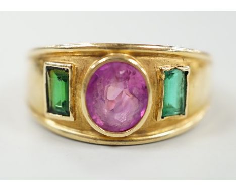 A modern 14k, collet set ruby and green paste? three stone ring, size L, gross weight 4 grams.