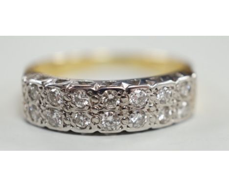 A modern 18ct gold and fourteen stone two row diamond set half hoop ring, size R/S, with textured shoulders, gross weight 5.4