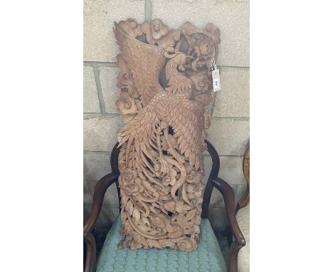 A South East Asian carved wood panel, width 34cm, height 92cm