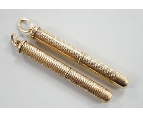 A 1950's engine turned 9ct gold mounted propelling toothpick, 48mm and a similar yellow metal mounted toothpick.