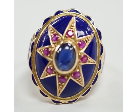 A yellow metal, blue enamel, ruby and cabochon sapphire set oval dress ring, the shank inscribed 'Sister My Sister?' size O, 