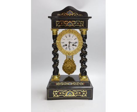 A French Napoleon III ebonised and brass inlaid portico clock. 49cm tall