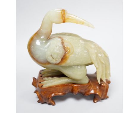 A Chinese green and russet jade figure of a crane, 11.5cm long, wood stand Provenance - the former owner collected jades and 