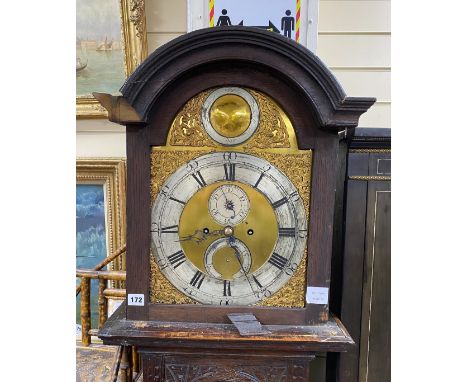 An 18th century oak 8 day longcase clock, with later carved decoration, the silvered chapter ring with Arabic and black Roman
