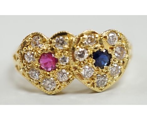 A modern 18ct gold, ruby, sapphire and diamond set twin heart cluster ring, size M, gross weight 4 grams.