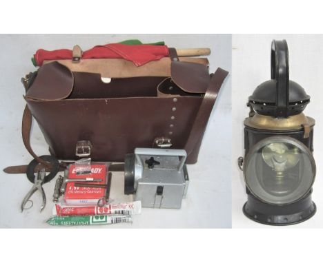 A Lot containing a Guards leather satchel containing both red and green flags. Bardic lamp with spare battery. Light sticks. 