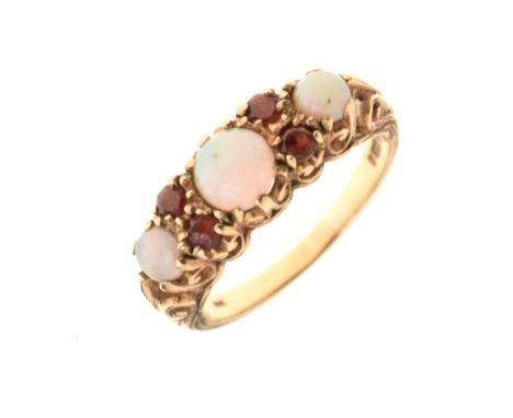 9ct gold dress ring set three circular opal cabochons and four small red stones, size O, 3.2g gross approx Condition: One sma