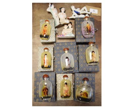 Four Chinese ceramic erotic figures, 20th Century, together with eight reproduction Chinese snuff bottles internally decorate
