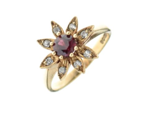 9ct gold dress ring set red garnet-coloured stone within flowerhead border of white stones, size N½, 2.8g gross approx Condit