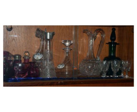 Quantity of cranberry glass together with a selection of clear cut glass decanters etc Condition: The silver mounted claret j