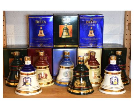 Collection of eight Bell's Aged 8 Years Extra Special Old Scotch Whisky ceramic bell shaped decanters commemorating various R